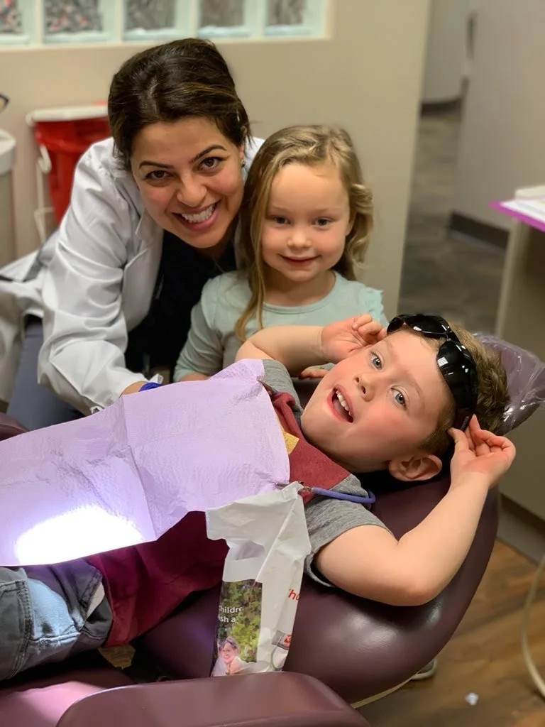 Dr. Kaur with two children smiling at Kokopelli Dentistry